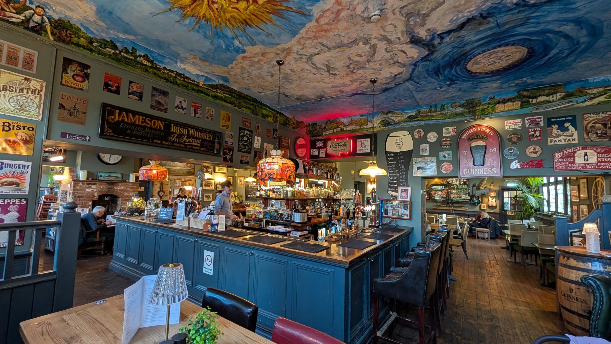 Main bar with old signs and ceiling art. (Bar). Published on 12-04-2026