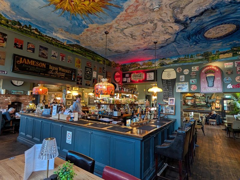 Main bar with old signs and ceiling art. (Bar). Published on 12-04-2026 