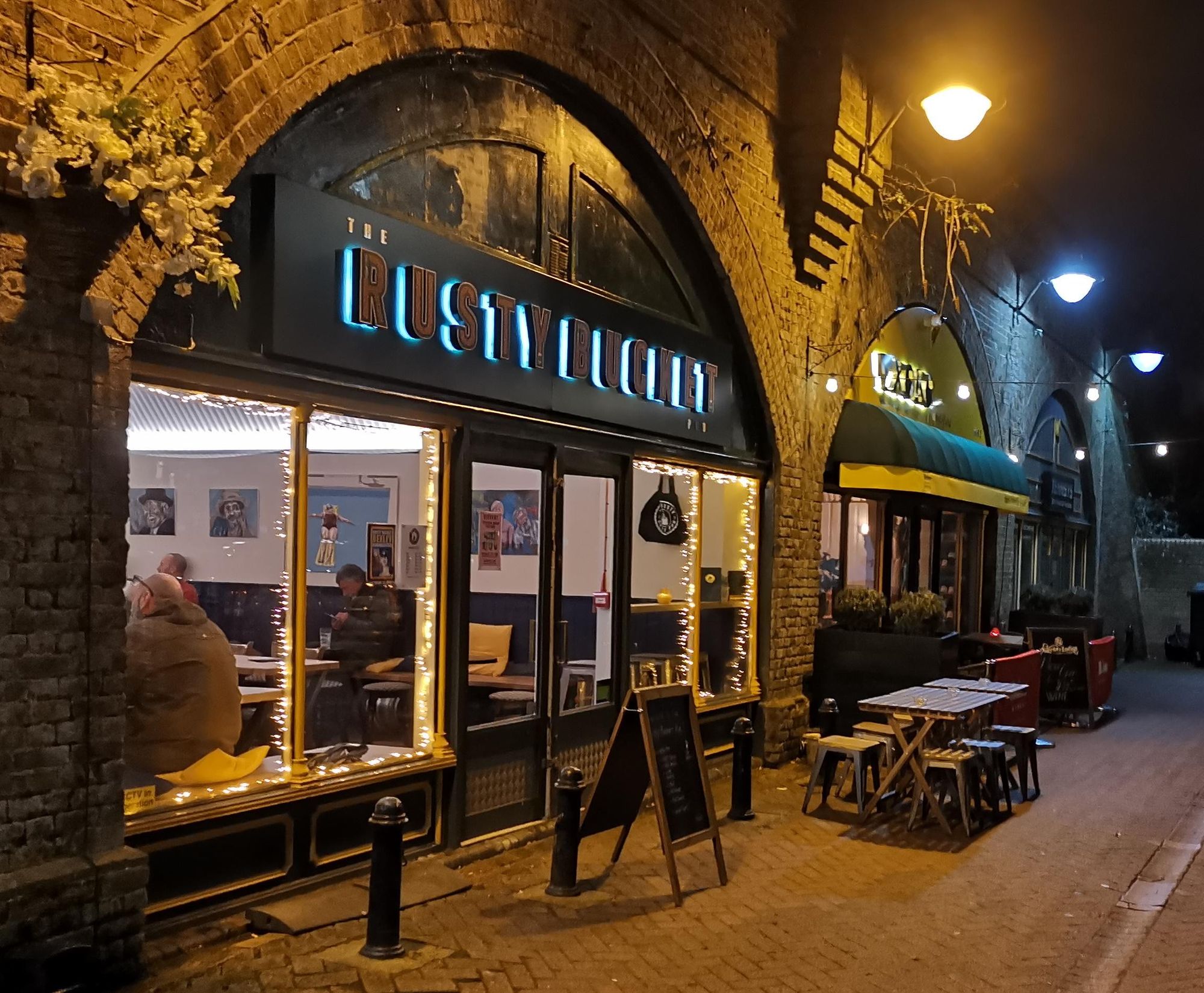 Pub exterior beneath the arch by night. (Pub, External, Sign, Key). Published on 28-01-2025