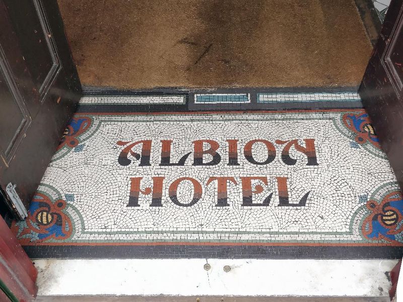 Mosaic of former name in entrance. (Pub). Published on 03-05-2019