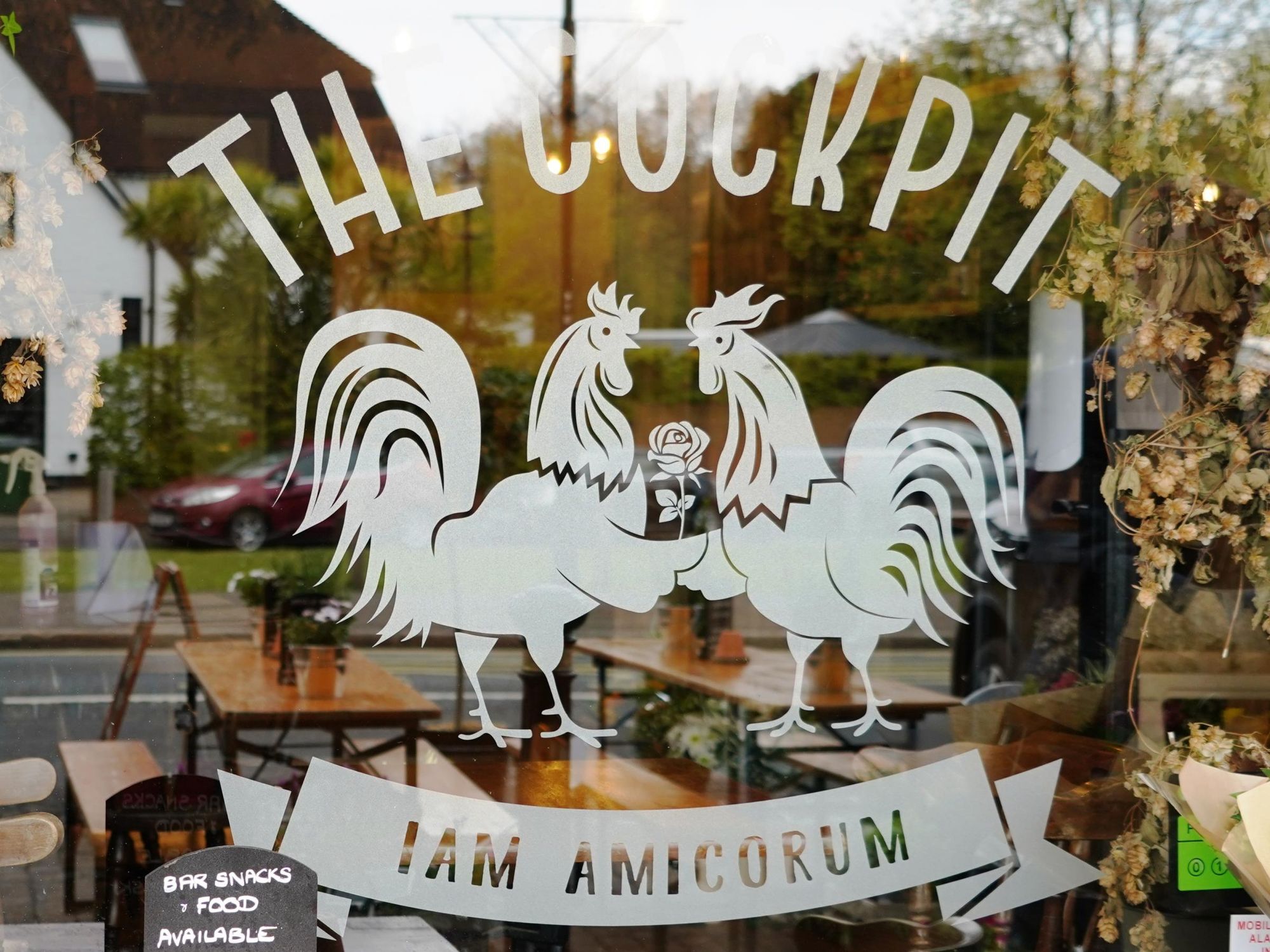 Photo taken 5 May 2021 window sign, with Latin moto.. (Pub, Sign). Published on 06-05-2021
