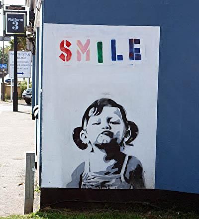 A mural on the side of the pub of a young girl with the word "sm. (External). Published on 04-09-2013
