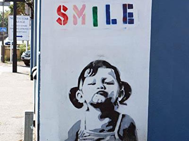 A mural on the side of the pub of a young girl with the word "sm. (External). Published on 04-09-2013