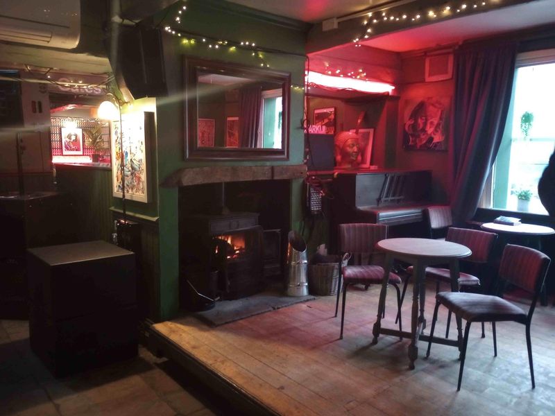 Seating area and stage area with fire. (Pub). Published on 13-01-2024