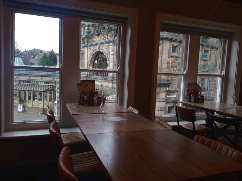 Upstairs seating with view of Buxton Opera House outside. (Pub). Published on 08-12-2024