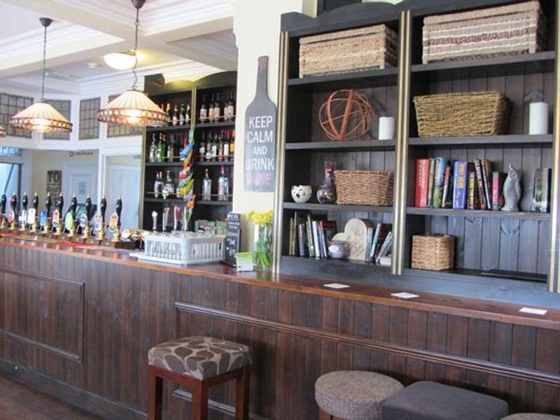 Wide of Main bar with bookcase along with books and ornaments. (Pub, Bar). Published on 28-04-2014