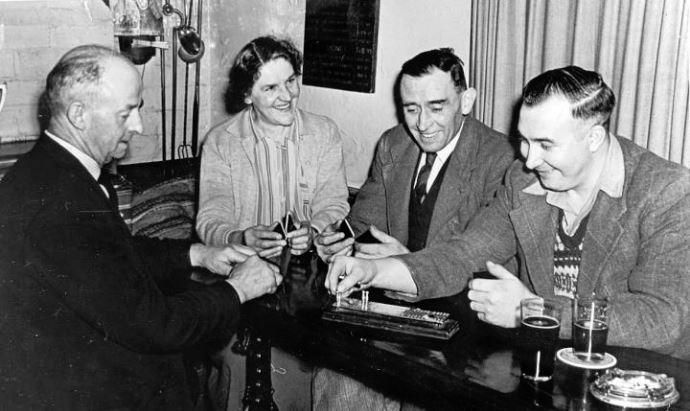 c1960, landlady Isabella Arnott plays crib with three of her cus. (Pub, Publican, Customers). Published on 30-09-2020