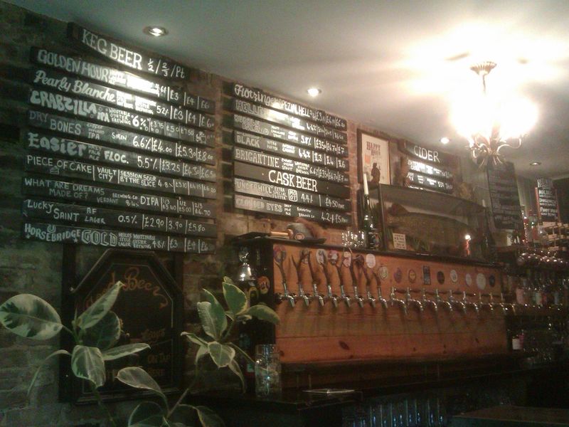 Beer menu and the wall of keg taps. (Bar). Published on 22-08-2024