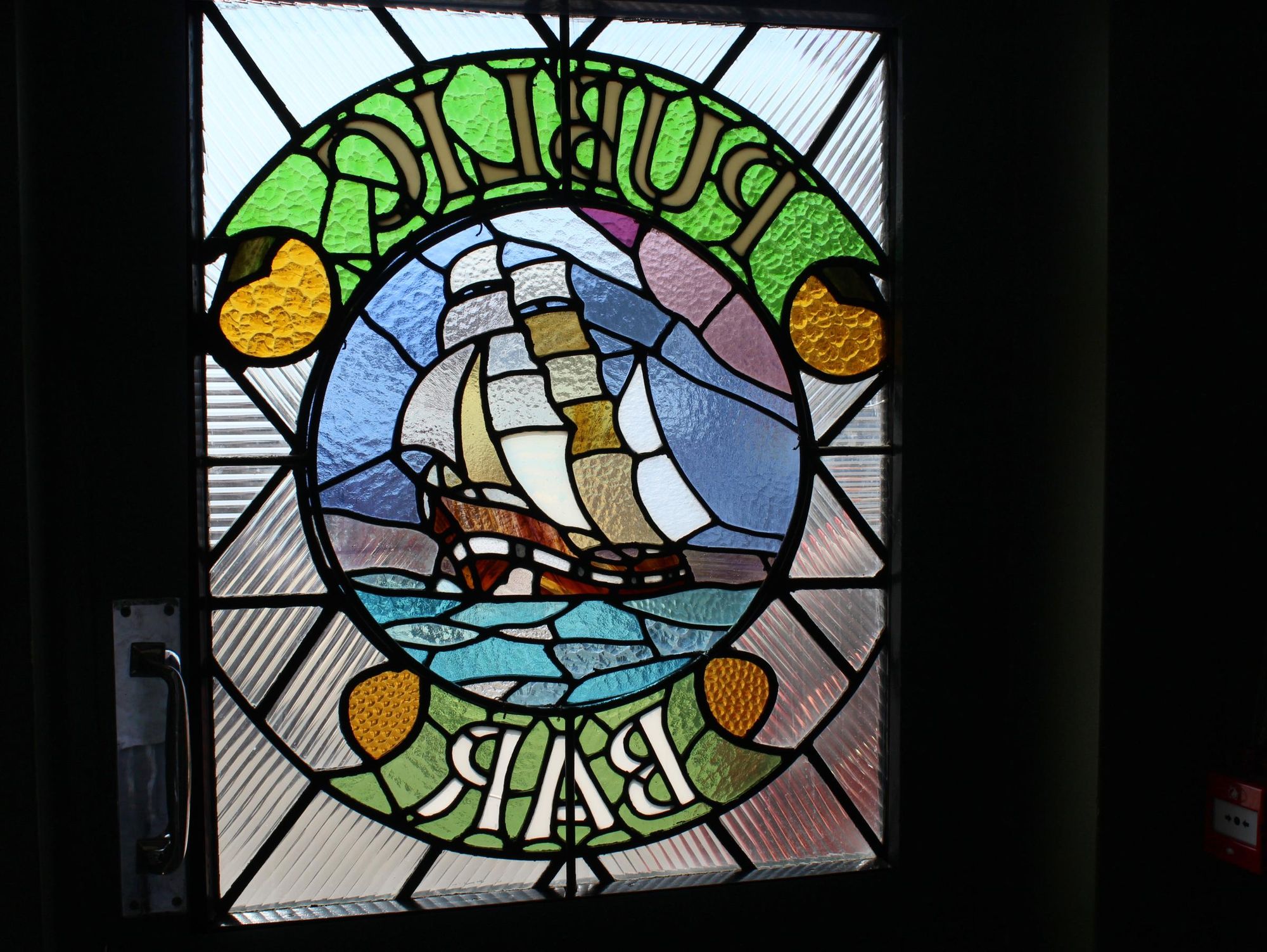 The stained glass window proclaiming "Public Bar", with an image. (Pub). Published on 14-09-2025